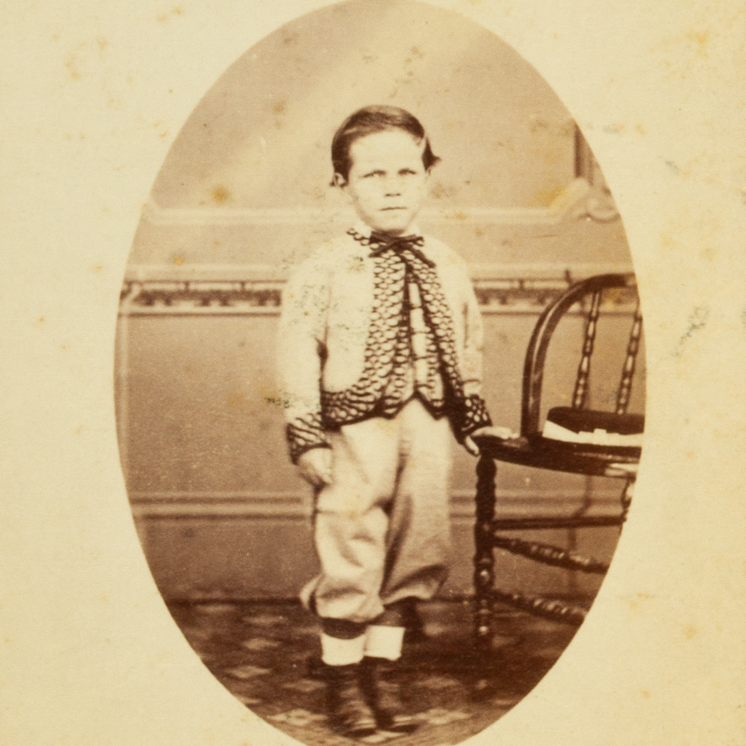 Studio portrait of a young boy wearing an embroidered jacket. Yass (or ...