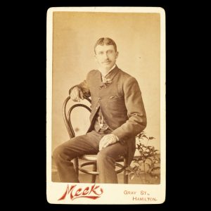 Studio portrait of a dapper young man seated on a chair. Hamilton, Victoria, c.1890.