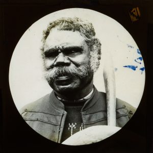 A Queensland Aboriginal man holding a throwing club and boomerang (possibly at Deebing Creek Mission, Ipswich), 1890s.