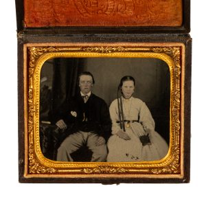 Ambrotype of a young married couple seated side-by-side.