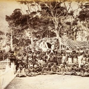 Large group of villagers with three European men. India, c.1880.