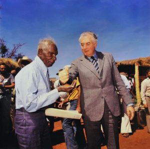 Prime Minister Gough Whitlam pours soil into hand of traditional [Gurindji] landowner Vincent Lingiari, [Daguragu/Wattie Creek] Northern Territory.