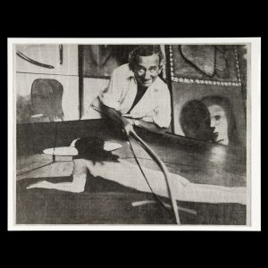 Charles Blackman sawing a painting, c.1975