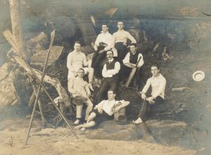 Men at leisure: a spot of rowing, some beach cricket, a picnic hamper, and a bottle of wine. Near Melbourne, c.1910.
