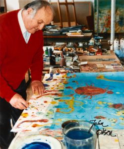 A signed photograph of John Olsen in his studio