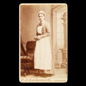 Studio portrait of a woman in nurse's uniform. Launceston, Tasmania, c.1885.