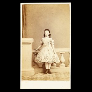 Studio portrait of a young girl in an embroidered white dress. Hobart Town, Tasmania, early 1860s.